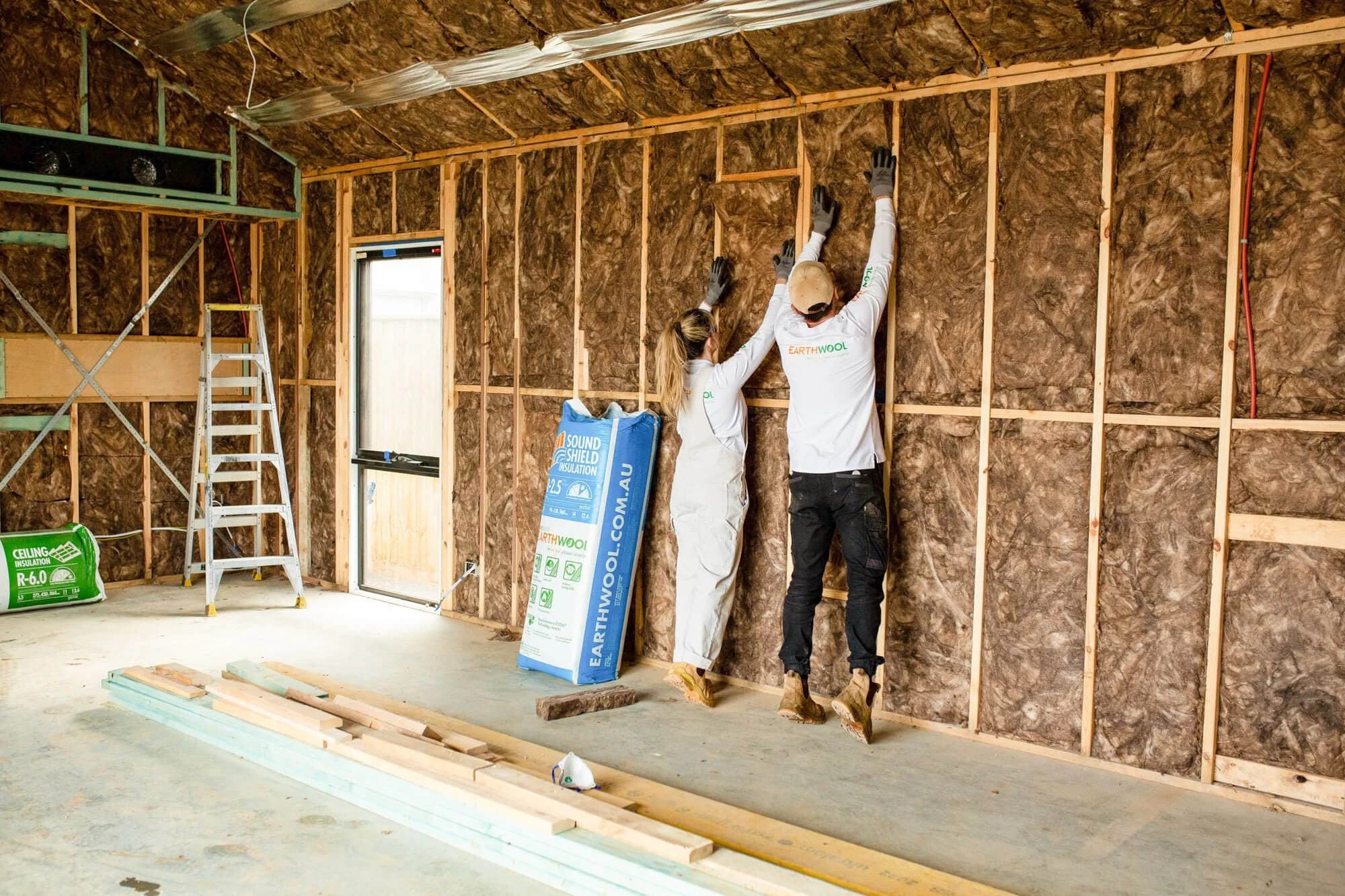 Earthwool insulation being installed in walls