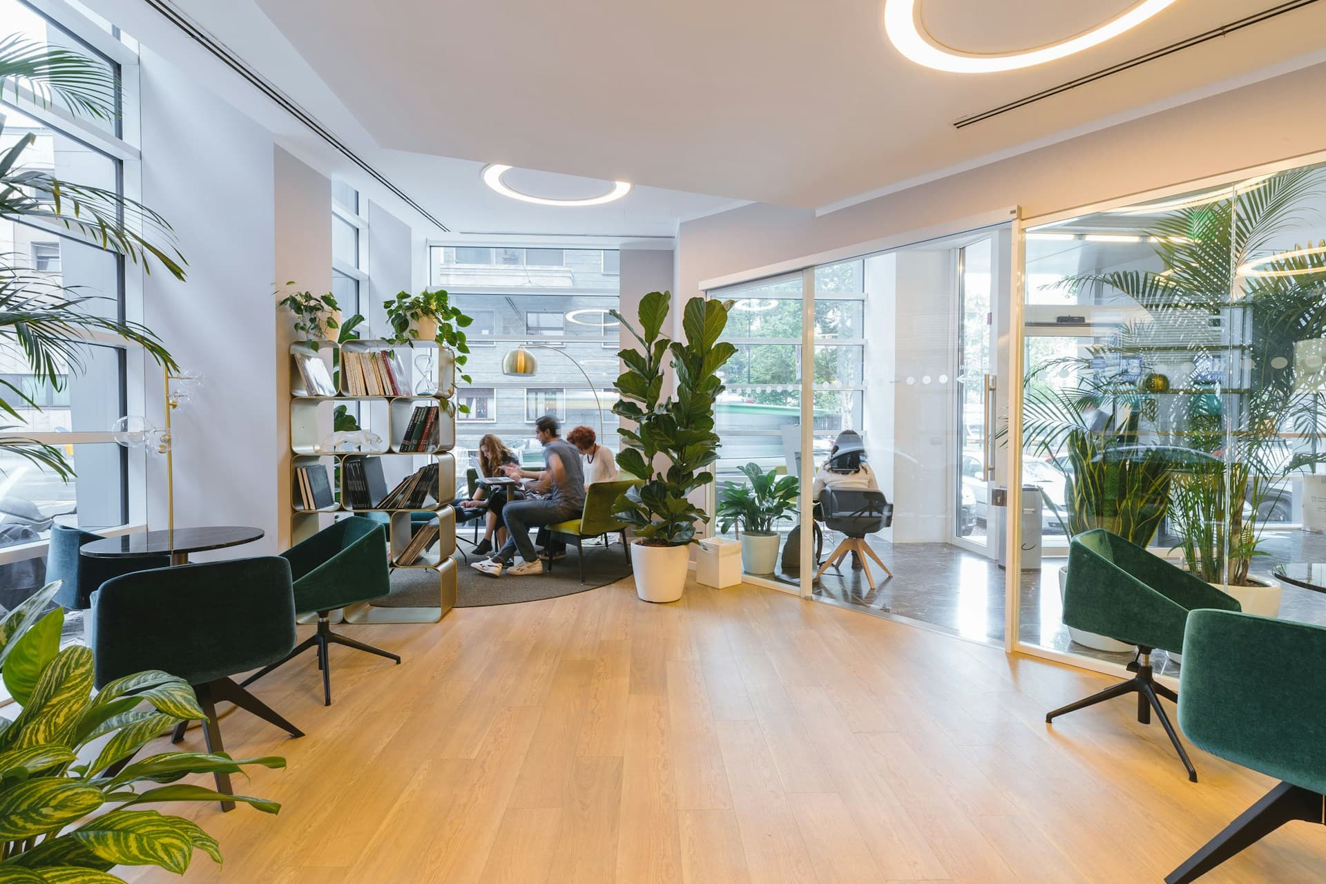 modern office breakout area with lounge chairs and indoor plants